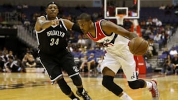 Oct 8, 2013; Washington, DC, USA; Washington Wizards small forward Trevor Ariza (1) dribbles the ball as Brooklyn Nets small forward Paul Pierce (34) defends in the first quarter at Verizon Center. Mandatory Credit: Geoff Burke-USA TODAY Sports