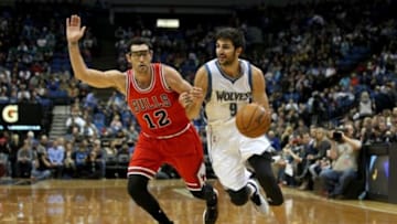 Nov 1, 2014; Minneapolis, MN, USA; Minnesota Timberwolves guard Ricky Rubio (9) drives past Chicago Bulls guard Kirk Hinrich (12) during the third quarter at Target Center. The Bulls defeated the Timberwolves 106-105. Mandatory Credit: Brace Hemmelgarn-USA TODAY Sports