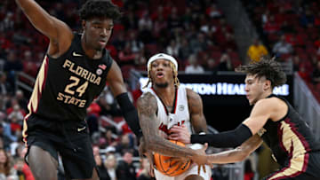 Feb 4, 2023; Louisville, Kentucky, USA; Louisville Cardinals guard El Ellis (3) drives to the basket against Florida State Seminoles center Naheem McLeod (24) and guard Jalen Warley (1) during the second half at KFC Yum! Center. Florida State defeated Louisville 81-78. Mandatory Credit: Jamie Rhodes-USA TODAY Sports