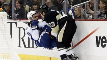 Dec 15, 2014; Pittsburgh, PA, USA; Pittsburgh Penguins right wing Steve Downie (23) checks Tampa Bay Lightning defenseman Mark Barberio (8) behind the net during the second period at the CONSOL Energy Center. The Penguins won 4-2. Mandatory Credit: Charles LeClaire-USA TODAY Sports