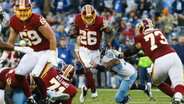 NASHVILLE, TN - DECEMBER 22: Adrian Peterson #26 of the Washington Redskins is defended by Rashaan Evans #54 of the Tennessee Titans while running with the ball during the second quarter at Nissan Stadium on December 22, 2018 in Nashville, Tennessee. (Photo by Frederick Breedon/Getty Images)