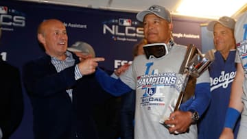 MILWAUKEE, WI - OCTOBER 20: Dave Roberts #30 of the Los Angeles Dodgers celebrates with the Warren C. Giles Trophy after defeating the Milwaukee Brewers in Game Seven to win the National League Championship Series at Miller Park on October 20, 2018 in Milwaukee, Wisconsin. (Photo by Jeff Roberson - Pool/Getty Images)