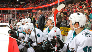 CALGARY, AB DECEMBER 14, 2017: Teammates of the San Jose Sharks sit on the bench in a game against the Calgary Flames at the Scotiabank Saddledome on Saturday night. (Photo by Brad Watson/NHLI via Getty Images)