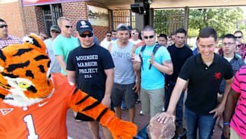 The Clemson Tiger mascot, left, rubs Howard's Rock with Noel Montoya, right, one of 40 U.S. Marines participating in the Honoring Their Service event at Death Valley.2014 Clemson Growth Visitors
