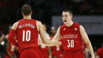 MIAMI, FLORIDA - NOVEMBER 05: Ryan McMahon #30 of the Louisville Cardinals celebrates with Samuell Williamson #10 after a basket against the Miami Hurricanes during the first half at Watsco Center on November 05, 2019 in Miami, Florida. (Photo by Michael Reaves/Getty Images)