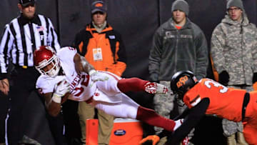 Nov 28, 2015; Stillwater, OK, USA; Oklahoma Sooners running back Samaje Perine (32) dives into the end zone for a touchdown ahead of Oklahoma State Cowboys defensive end Emmanuel Ogbah (38) at Boone Pickens Stadium. Mandatory Credit: Alonzo Adams-USA TODAY Sports