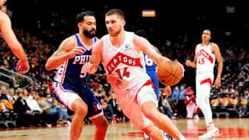 Oct 4, 2021; Toronto, Ontario, CAN; Toronto Raptors guard Svi Mykhailiuk (14) drives to the basket past Philadelphia 76ers guard Grant Riller (5) during the second half at Scotiabank Arena. Mandatory Credit: John E. Sokolowski-USA TODAY Sports