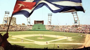 A Cuban fan waves the Cuban flag during the historic baseball game between the Baltimore Orioles and the Cuban national team at LatinoAmericano Stadium in Havana, Cuba 28 March, 1999. The Baltimore Orioles won the contest in 3-2 in eleven innings. AFP PHOTO/Adalberto ROQUE (Photo by Adalberto ROQUE / AFP) (Photo by ADALBERTO ROQUE/AFP via Getty Images)