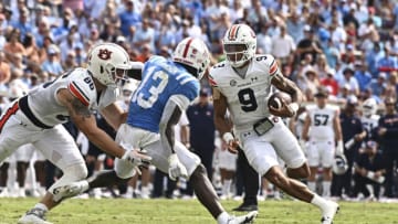 Oct 15, 2022; Oxford, Mississippi, USA; Auburn Tigers quarterback Robby Ashford (9) runs the ball while defended by Mississippi Rebels safety Ladarius Tennison (13) during the fourth quarter at Vaught-Hemingway Stadium. Mandatory Credit: Matt Bush-USA TODAY Sports