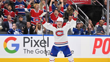 Oct 2, 2023; Toronto, Ontario, CAN; Montreal Canadiens forward Cole Caufield (22) celebrates after assisting on the winnig goal scored by forward Nick Suzuki (not pictured) in overtime against the Toronto Maple Leafs at Scotiabank Arena. Mandatory Credit: Dan Hamilton-USA TODAY Sports