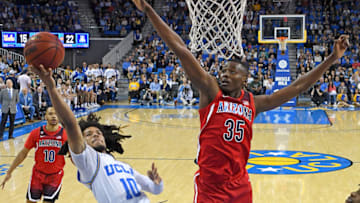LOS ANGELES, CA - FEBRUARY 29: Tyger Campbell #10 of the UCLA Bruins gets by Christian Koloko #35 of the Arizona Wildcats for a basket in the game at Pauley Pavilion on February 29, 2020 in Los Angeles, California. (Photo by Jayne Kamin-Oncea/Getty Images)