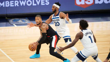 Josh Okogie and Anthony Edwards of the Minnesota Timberwolves defend against Damian Lillard of the Portland Trail Blazers. (Photo by Hannah Foslien/Getty Images)