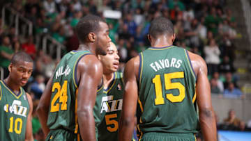 SALT LAKE CITY, UT - MARCH 17: Teammates Derrick Favors #15, Paul Millsap #24, Devin Harris #5 and Alec Burks #10 of the Utah Jazz talk during the game against the Golden State Warriors at Energy Solutions Arena on March 17, 2012 in Salt Lake City, Utah. Copyright 2012 NBAE (Photo by Melissa Majchrzak/NBAE via Getty Images)
