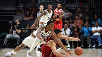 Dec 31, 2016; Coral Gables, FL, USA; Miami Hurricanes forward Dewan Huell (20) and North Carolina State Wolfpack center Omer Yurtseven (14) both reach for a loose ball during the second half at Watsco Center. Miami won 81-63. Mandatory Credit: Steve Mitchell-USA TODAY Sports