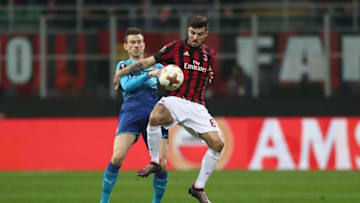 MILAN, ITALY - MARCH 08: Patrick Cutrone of AC Milan is challenged by Laurent Koscielny of Arsenal during the UEFA Europa League Round of 16 match between AC Milan and Arsenal at the San Siro on March 8, 2018 in Milan, Italy. (Photo by Catherine Ivill/Getty Images)