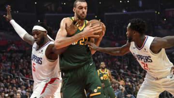 Jan 16, 2019; Los Angeles, CA, USA; Utah Jazz center Rudy Gobert (27) is defended by LA Clippers forward Montrezl Harrell (5) and guard Patrick Beverley (21) in the second half at Staples Center. The Jazz defeated the Clippers 129-109. Mandatory Credit: Kirby Lee-USA TODAY Sports