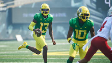 Sep 4, 2021; Eugene, Oregon, USA; Oregon Ducks quarterback Anthony Brown (13) picks up a first down during the first half against the Fresno State Bulldogs at Autzen Stadium. Mandatory Credit: Troy Wayrynen-USA TODAY Sports