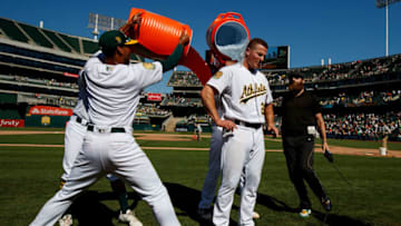 OAKLAND, CA - JULY 22: Matt Chapman #26 of the Oakland Athletics has Gatorade poured on him by teammates after hitting a walk off RBI single after the game against the San Francisco Giants at the Oakland Coliseum on July 22, 2018 in Oakland, California. The Oakland Athletics defeated the San Francisco Giants 6-5 in 10 innings. (Photo by Jason O. Watson/Getty Images)