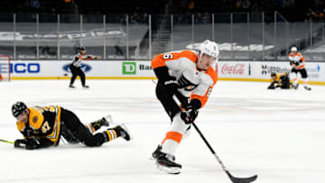 Apr 5, 2021; Boston, Massachusetts, USA; Philadelphia Flyers defenseman Travis Sanheim (6) skates with the puck past Boston Bruins center Patrice Bergeron (37) during an overtime period at the TD Garden. Mandatory Credit: Brian Fluharty-USA TODAY Sports