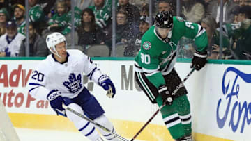 Jason Spezza #90 of the Dallas Stars skates the puck against Dominic Moore #20 of the Toronto Maple Leafs. (Photo by Ronald Martinez/Getty Images)