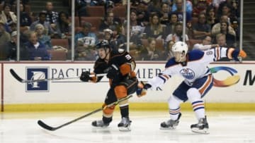 Apr 1, 2015; Anaheim, CA, USA; Anaheim Ducks right wing Jakob Silfverberg (left) passes the puck defended by Edmonton Oilers defenseman Oscar Klefbom (right) during the second quarter at Honda Center. Mandatory Credit: Kelvin Kuo-USA TODAY Sports