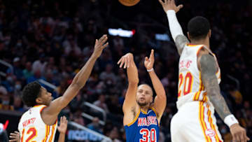 November 8, 2021; San Francisco, California, USA; Golden State Warriors guard Stephen Curry (30) shoots the basketball against Atlanta Hawks forward De'Andre Hunter (12) and forward John Collins (20) during the fourth quarter at Chase Center. Mandatory Credit: Kyle Terada-USA TODAY Sports
