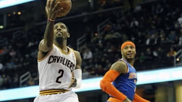 Dec 10, 2013; Cleveland, OH, USA; Cleveland Cavaliers point guard Kyrie Irving (2) drives to the basket against New York Knicks small forward Carmelo Anthony (7) in the first quarter at Quicken Loans Arena. Mandatory Credit: David Richard-USA TODAY Sports