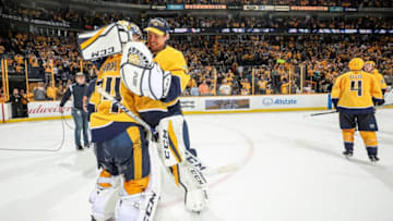 NASHVILLE, TN - MARCH 29: Pekka Rinne #35 congratulates Juuse Saros #74 of the Nashville Predators on a 5-3 win against the San Jose Sharks during an NHL game at Bridgestone Arena on March 29, 2018 in Nashville, Tennessee. (Photo by John Russell/NHLI via Getty Images)