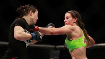 LAS VEGAS, NV - JANUARY 31: Miesha Tate (R) punches Sara McMann in their bantamweight bout during UFC 183 at the MGM Grand Garden Arena on January 31, 2015 in Las Vegas, Nevada. Tate won the fight by majority decision. (Photo by Steve Marcus/Getty Images)