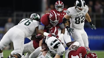 Dec 31, 2015; Arlington, TX, USA; Michigan State Spartans quarterback Connor Cook (18) is tackled by Alabama Crimson Tide linebacker Reggie Ragland (19) and defensive lineman Jonathan Allen (93) in the 2015 CFP semifinal at the Cotton Bowl at AT&T Stadium. Mandatory Credit: Matthew Emmons-USA TODAY Sports