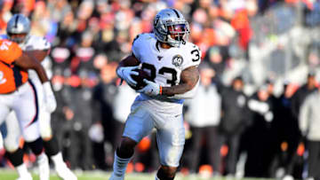 Dec 29, 2019; Denver, Colorado, USA; Oakland Raiders running back DeAndre Washington (33) carries the ball in the second quarter against the Denver Broncos at Empower Field at Mile High. Mandatory Credit: Ron Chenoy-USA TODAY Sports