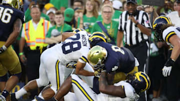 SOUTH BEND, IN - SEPTEMBER 01: Jafar Armstrong #8 of the Notre Dame Fighting Irish carries the ball against Brandon Watson #28 and Rashan Gary #3 of the Michigan Wolverines in the first quarter at Notre Dame Stadium on September 1, 2018 in South Bend, Indiana. (Photo by Gregory Shamus/Getty Images)