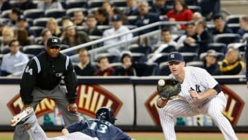 May 14, 2013; Bronx, NY, USA; Seattle Mariners second baseman Dustin Ackley (13) slides back to first as New York Yankees first baseman Lyle Overbay (55) waits for the ball during the eighth inning at Yankee Stadium. Yankees won 4-3. Mandatory Credit: Anthony Gruppuso-USA TODAY Sports