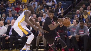 November 20, 2015; Oakland, CA, USA; Chicago Bulls guard Jimmy Butler (21, right) dribbles against Golden State Warriors forward Draymond Green (23, left) during the third quarter at Oracle Arena. The Warriors defeated the Bulls 106-94. Mandatory Credit: Kyle Terada-USA TODAY Sports