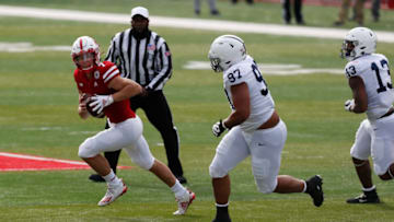 Nov 14, 2020; Lincoln, Nebraska, USA; Nebraska Cornhuskers quarterback Luke McCaffrey runs against Penn State Nittany Lions defensive tackle PJ Mustipher (97) in the first half at Memorial Stadium. Mandatory Credit: Bruce Thorson-USA TODAY Sports
