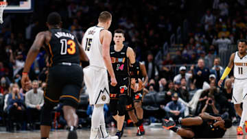 Nov 8, 2021; Denver, Colorado, USA; Miami Heat forward Markieff Morris (8) lies on the ground after a play with Denver Nuggets center Nikola Jokic (15) as guard Tyler Herro (14) and center Bam Adebayo (13) react in the fourth quarter at Ball Arena. Mandatory Credit: Isaiah J. Downing-USA TODAY Sports