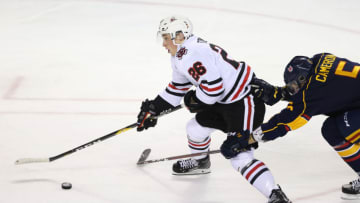 ST CATHARINES, ON - OCTOBER 11: Christopher Cameron #5 of the Barrie Colts struggles to contain Philip Tomasino #26 of the Niagara IceDogs during the first period of an OHL game at Meridian Centre on October 11, 2018 in St Catharines, Canada. (Photo by Vaughn Ridley/Getty Images)