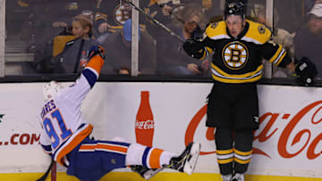 BOSTON - DECEMBER 9: Boston Bruins' Brad Marchand sends Islanders' John Tavares into the boards in the third period. The Boston Bruins host the New York Islanders in a regular season NHL hockey game at TD Garden in Boston on Dec. 9, 2017. (Photo by John Tlumacki/The Boston Globe via Getty Images)