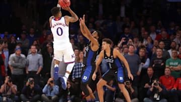 Nov 15, 2016; New York, NY, USA; Kansas Jayhawks guard Frank Mason (0) shoots the game winning shot against Duke Blue Devils guard Matt Jones (13) and forward Chase Jeter (2) during the second half at Madison Square Garden. Mandatory Credit: Brad Penner-USA TODAY Sports