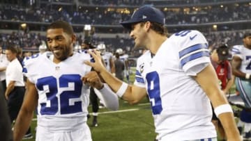Sep 28, 2014; Arlington, TX, USA; Dallas Cowboys quarterback Tony Romo (9) celebrates with cornerback Orlando Scandrick (32) after the game against the New Orleans Saints at AT&T Stadium. The Cowboys beat the Saints 38-17. Mandatory Credit: Matthew Emmons-USA TODAY Sports
