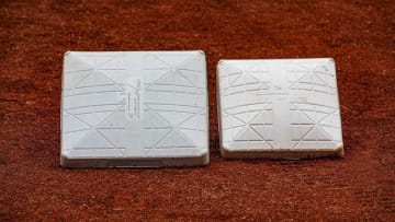 Bases sit side by side for size comparison in the dirt before a recent game at Louisville Slugger Field in Louisville, Ky. In an attempt to reduce player collisions and injuries, the size of the first, second and third bases in Triple-A was increased from 15 to 18 square inches.Jf Milb Bases 9x3a0593