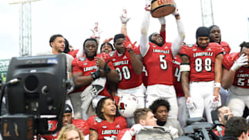 Dec 17, 2022; Boston, MA, USA; members of Louisville Cardinals celebrate winning the Wasabi Bowl at Fenway Park. Mandatory Credit: Eric Canha-USA TODAY Sports