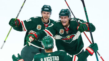 ST PAUL, MN - MAY 26: Nick Bonino #13 and Nico Sturm #7 of the Minnesota Wild celebrate after Nick Bjugstad #27 scores a goal during the third period against the Vegas Golden Knights in Game Six of the First Round of the 2021 Stanley Cup Playoffs at Xcel Energy Center on May 26, 2021 in St Paul, Minnesota. (Photo by Harrison Barden/Getty Images)