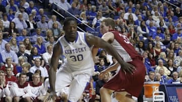 Nov 1, 2013; Lexington, KY, USA; Kentucky Wildcats forward Julius Randle (30) dribbles the ball around Transylvania Pioneers forward Chris Taylor (33) at Rupp Arena. Kentucky defeated Transylvania 76-42. Mandatory Credit: Mark Zerof-USA TODAY Sports