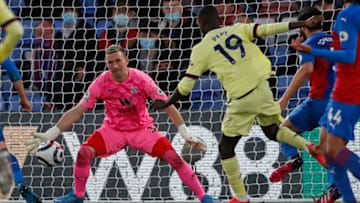 Arsenal's French-born Ivorian midfielder Nicolas Pepe (C) shoots to score their third goal during the English Premier League football match between Crystal Palace and Arsenal at Selhurst Park in south London on May 19, 2021. - Arsenal won the game 3-1. - RESTRICTED TO EDITORIAL USE. No use with unauthorized audio, video, data, fixture lists, club/league logos or 'live' services. Online in-match use limited to 120 images. An additional 40 images may be used in extra time. No video emulation. Social media in-match use limited to 120 images. An additional 40 images may be used in extra time. No use in betting publications, games or single club/league/player publications. (Photo by Frank Augstein / POOL / AFP) / RESTRICTED TO EDITORIAL USE. No use with unauthorized audio, video, data, fixture lists, club/league logos or 'live' services. Online in-match use limited to 120 images. An additional 40 images may be used in extra time. No video emulation. Social media in-match use limited to 120 images. An additional 40 images may be used in extra time. No use in betting publications, games or single club/league/player publications. / RESTRICTED TO EDITORIAL USE. No use with unauthorized audio, video, data, fixture lists, club/league logos or 'live' services. Online in-match use limited to 120 images. An additional 40 images may be used in extra time. No video emulation. Social media in-match use limited to 120 images. An additional 40 images may be used in extra time. No use in betting publications, games or single club/league/player publications. (Photo by FRANK AUGSTEIN/POOL/AFP via Getty Images)