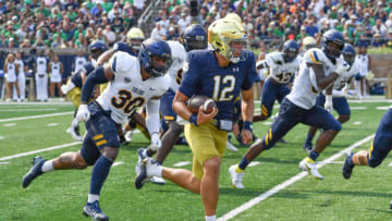Notre Dame Fighting Irish quarterback Tyler Buchner (12) carries in the second quarter against the Toledo Rockets at Notre Dame Stadium. Mandatory Credit: Matt Cashore-USA TODAY Sports