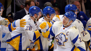 Dec 9, 2022; Buffalo, New York, USA; Buffalo Sabres right wing Kyle Okposo (21) celebrates his goal with teammates during the third period against the Pittsburgh Penguins at KeyBank Center. Mandatory Credit: Timothy T. Ludwig-USA TODAY Sports