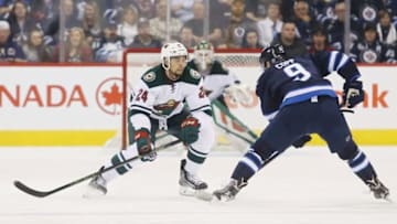 Apr 3, 2016; Winnipeg, Manitoba, CAN; Winnipeg Jets center Andrew Copp (9) makes his way past Minnesota Wild defenseman Matt Dumba (24) prior to his goal during the third period at MTS Centre. Winnipeg Jets win 5-1. Mandatory Credit: Bruce Fedyck-USA TODAY Sports