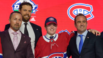 VANCOUVER, BC - JUNE 21: Cole Caufield poses for a photo onstage after being selected fifteenth overall by the Montreal Canadiens during the first round of the 2019 NHL Draft at Rogers Arena on June 21, 2019 in Vancouver, British Columbia, Canada. (Photo by Derek Cain/Icon Sportswire via Getty Images)