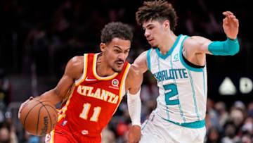 Nov 20, 2021; Atlanta, Georgia, USA; Atlanta Hawks guard Trae Young (11) dribbles the ball against Charlotte Hornets guard LaMelo Ball (2) during the second half at State Farm Arena. Mandatory Credit: Dale Zanine-USA TODAY Sports